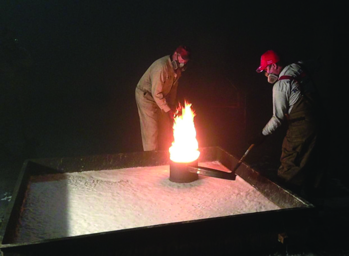 Technicians conduct a foam burn-back test