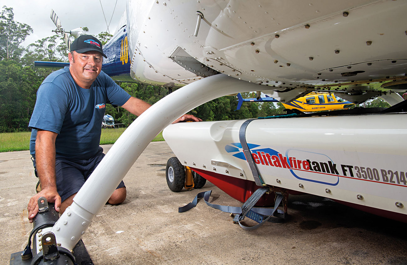 Jason Schellaars fitting the Helitak fire tank to the Bell 214ST airframe.