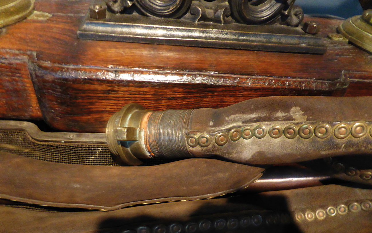 Old leather hose with brass screws.