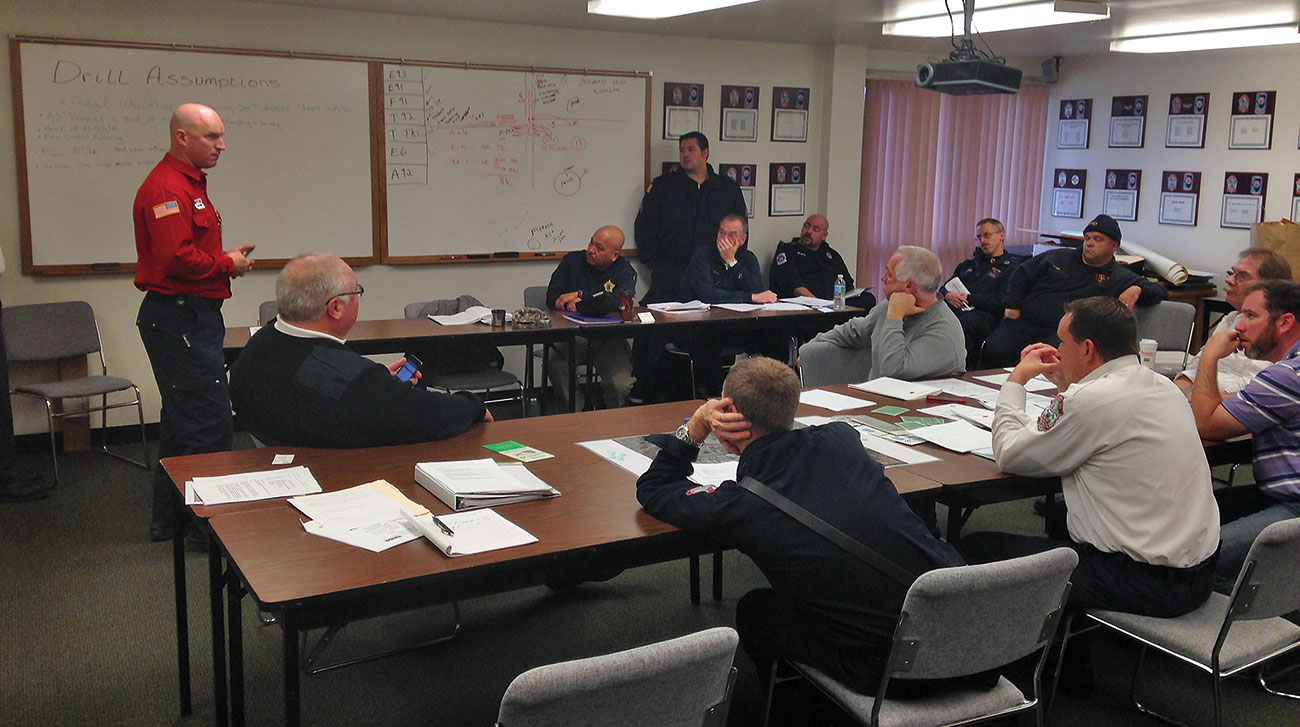 A group of Emergency Responders gather to review pre-plans for storage-tank emergencies. 