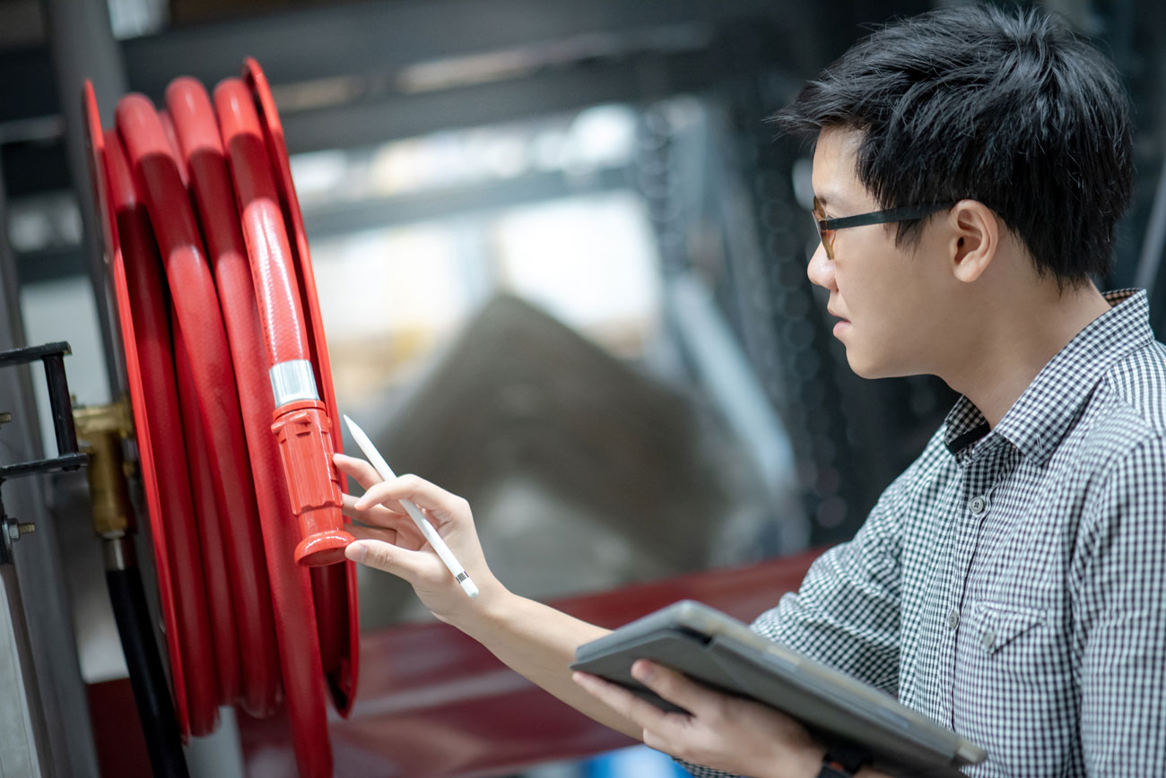Examining a fire safety hose reel using fire-safety management software. (PlanRadar)