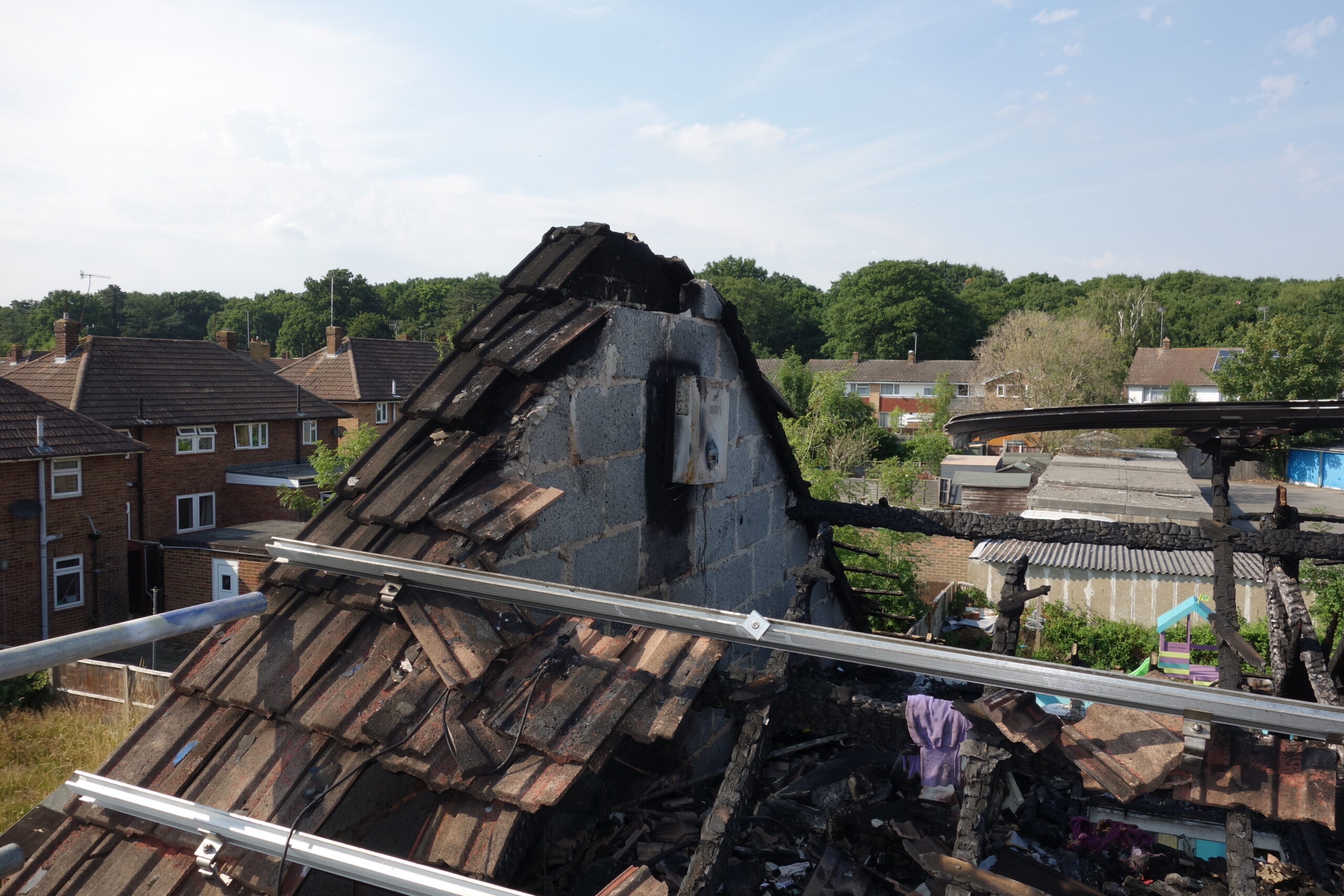 Damage to a roof resulting from a fire in a solar panel system.