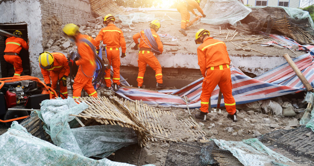 Search and rescue forces searching through a destroyed building.